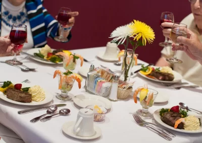 Senior citizens enjoying a gourmet meal at Garden Villas of Lenexa