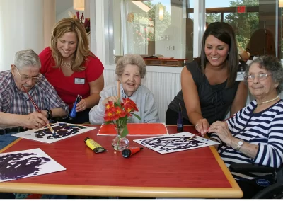 Delmar Gardens of Chesterfield with staff doing painting activities