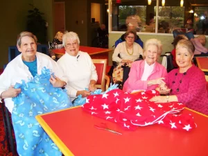 Delmar Gardens of Chesterfield residents making blankets. Respite Care Benefits.